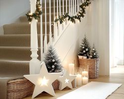 modern hallway and staircase with white and neutral Scandi style Christmas decorations